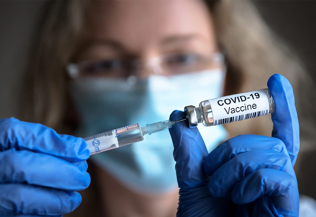 pharmacist administering the COVID vaccine