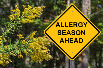 yellow warning sign with the phrase "allergy season ahead"