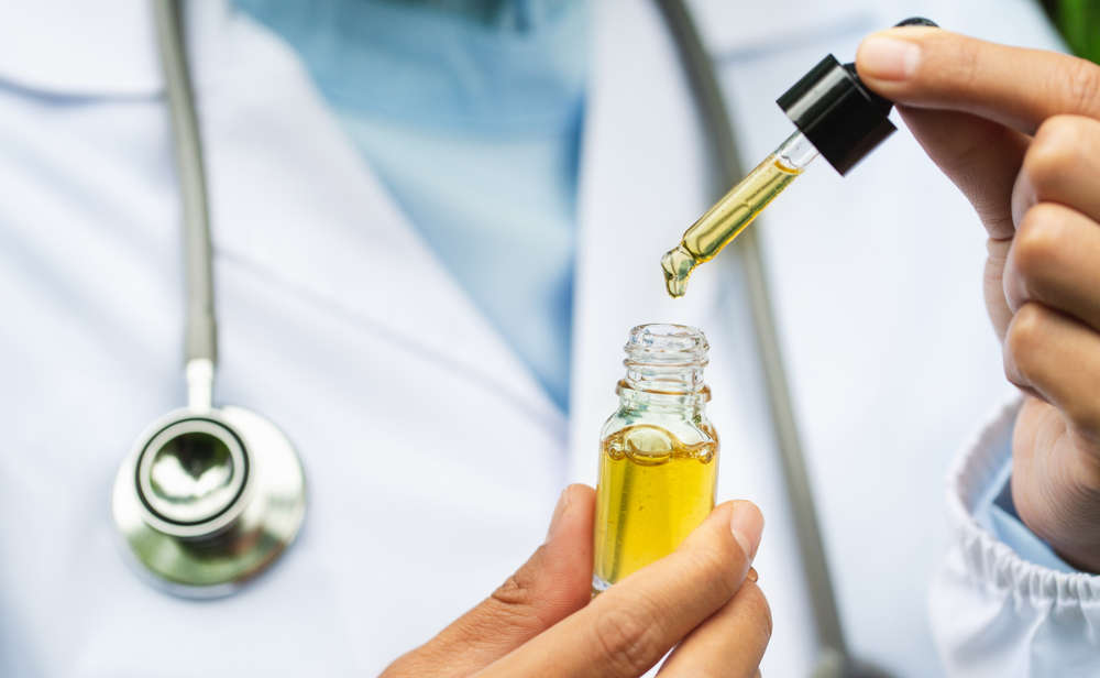 doctor drawing up CBD oil into a medicine dropper