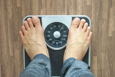 man standing on weight scale