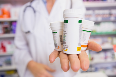 pharmacist with prescription bottles